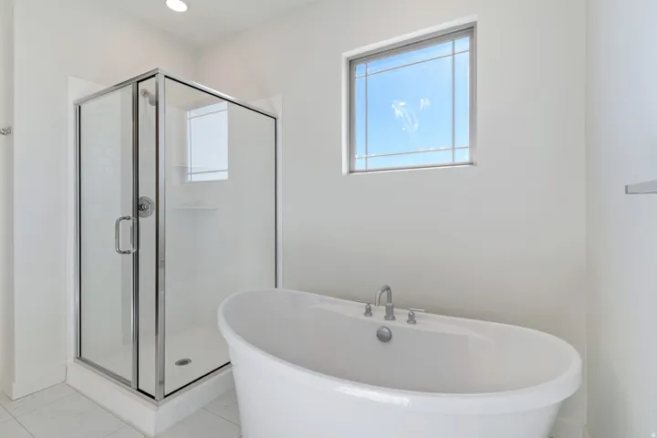 Bathroom featuring a freestanding tub, healthy amount of natural light, and a stall shower