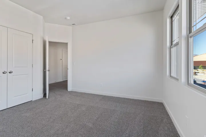 Unfurnished bedroom featuring carpet and a closet