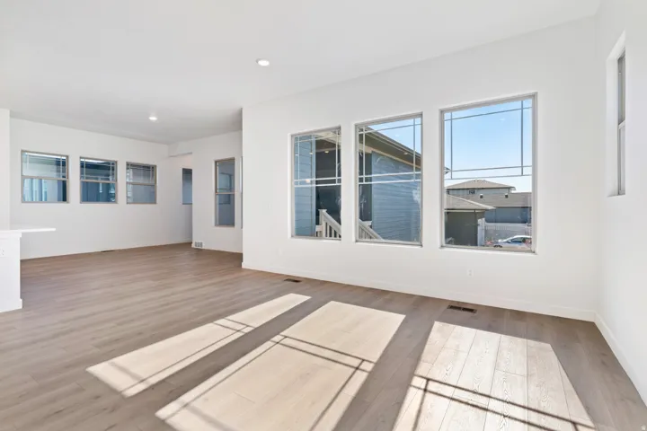 Empty room with light wood-style floors and recessed lighting