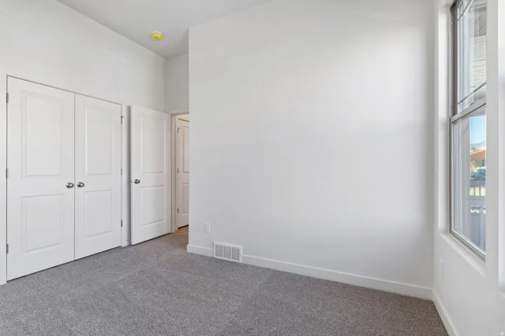 Unfurnished bedroom featuring carpet flooring and a closet