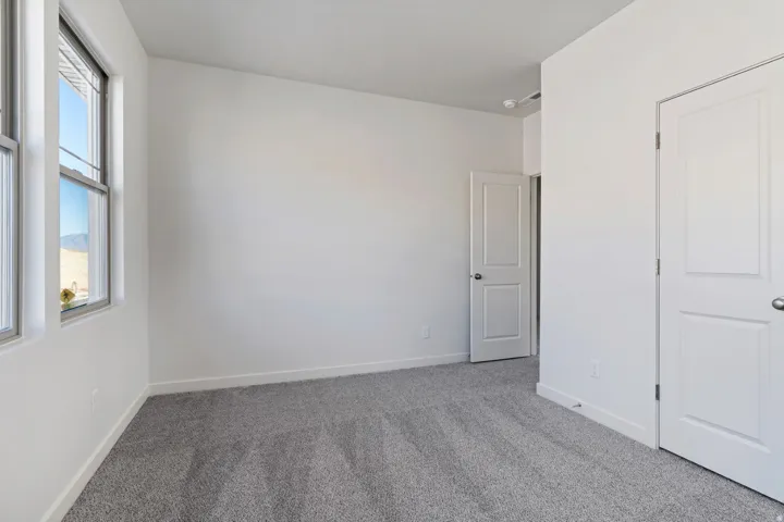 Unfurnished bedroom featuring carpet floors and baseboards