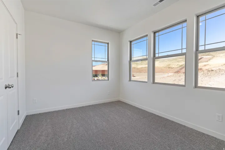Unfurnished room featuring carpet floors and baseboards