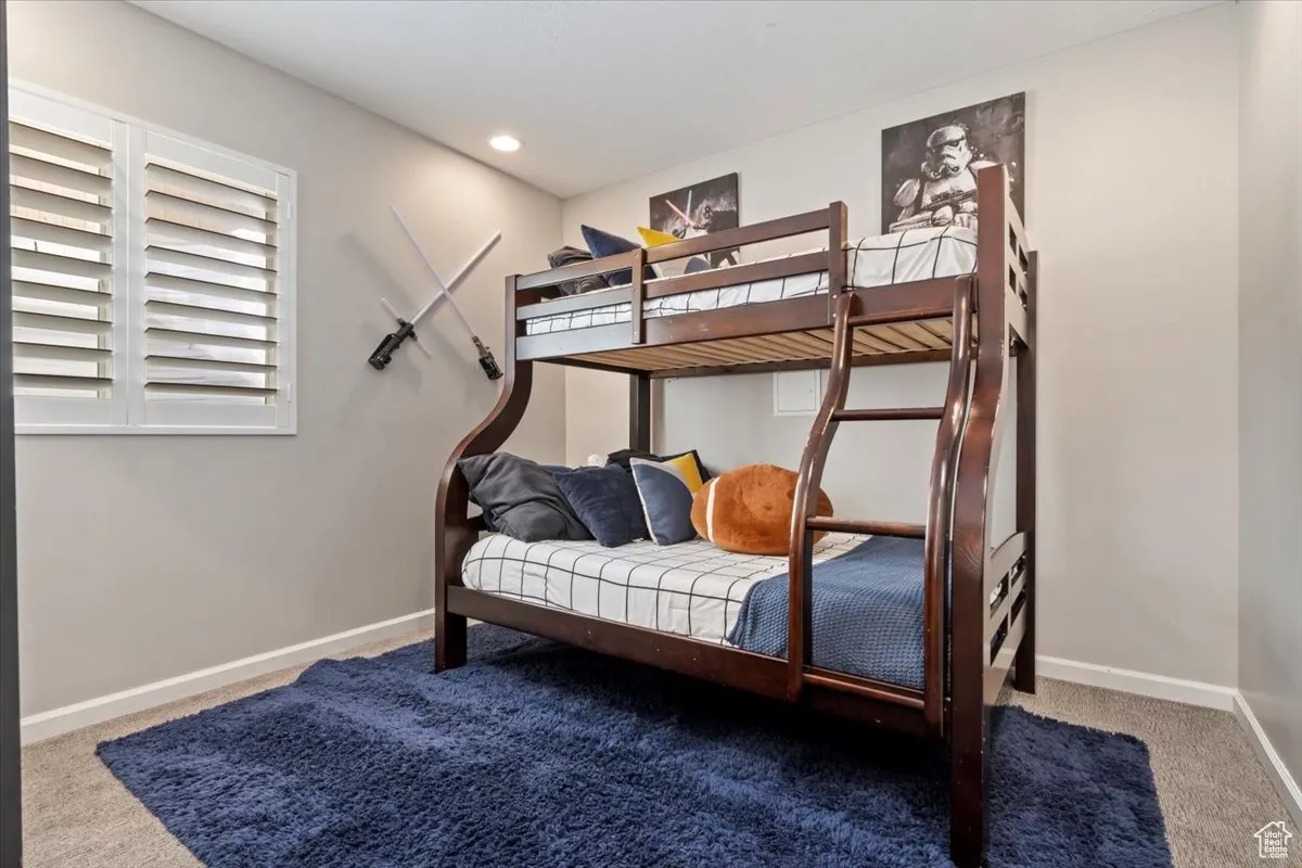 Carpeted bedroom with baseboards and recessed lighting