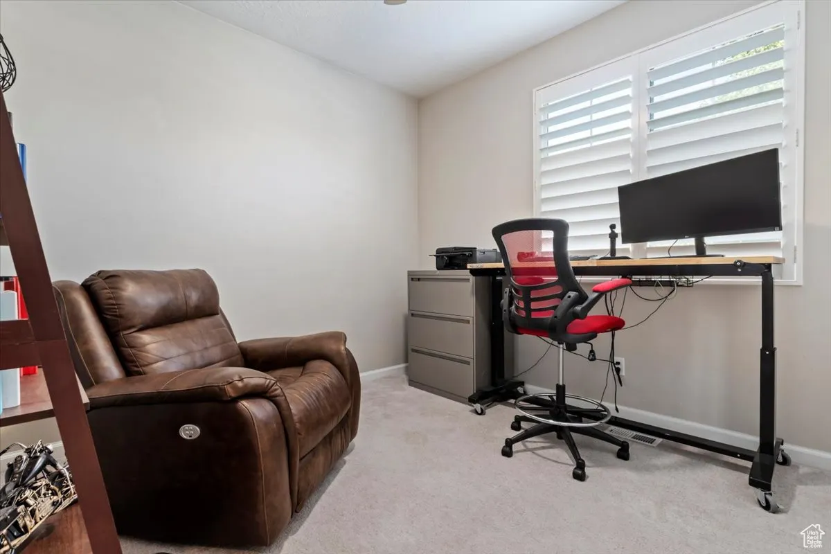 Carpeted office with baseboards