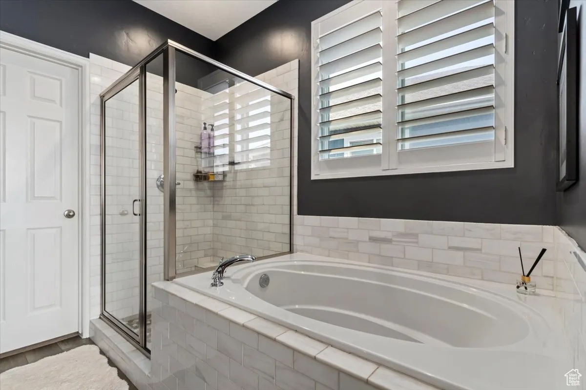 Bathroom with a shower stall and a garden tub