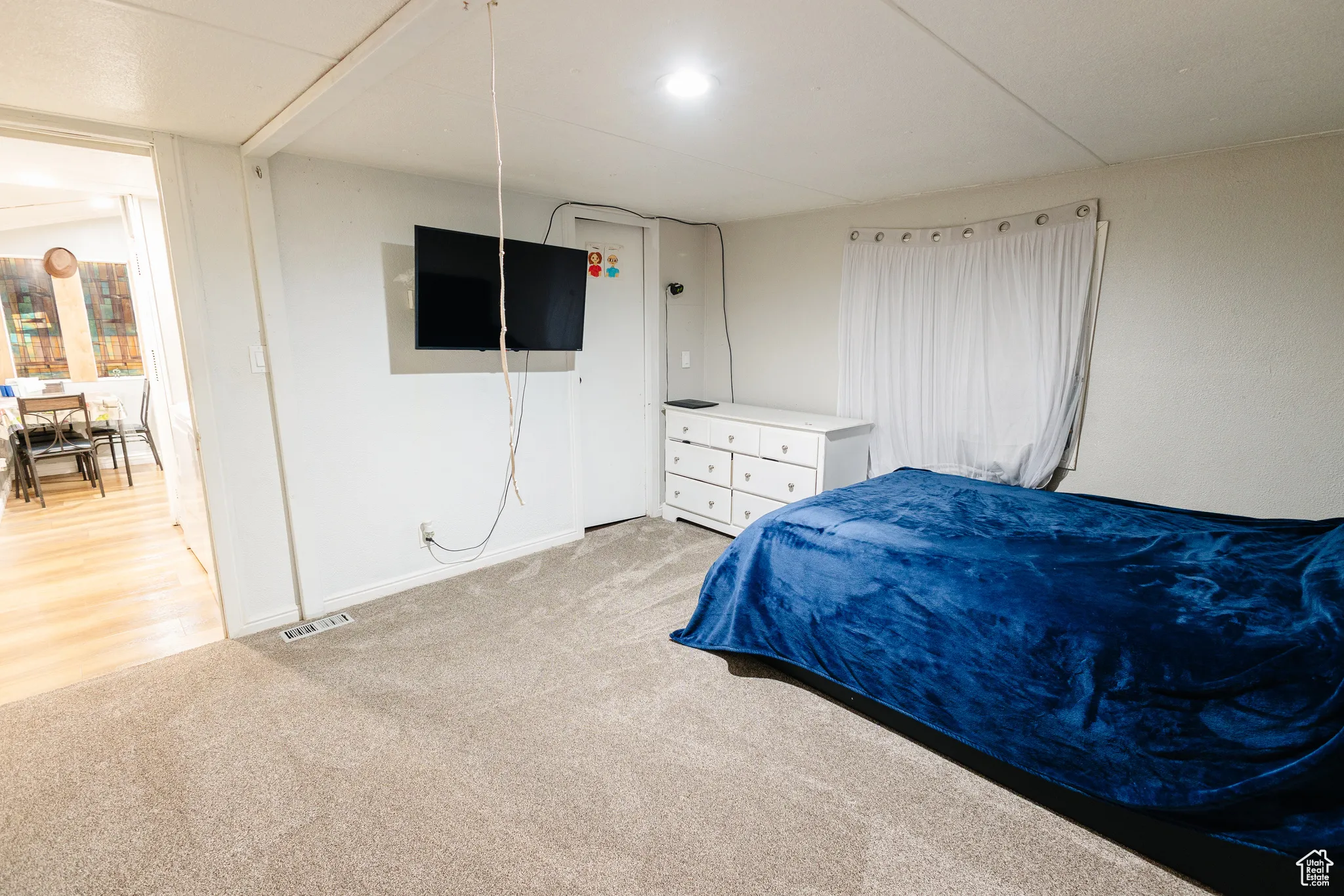 Bedroom featuring light colored carpet and baseboards