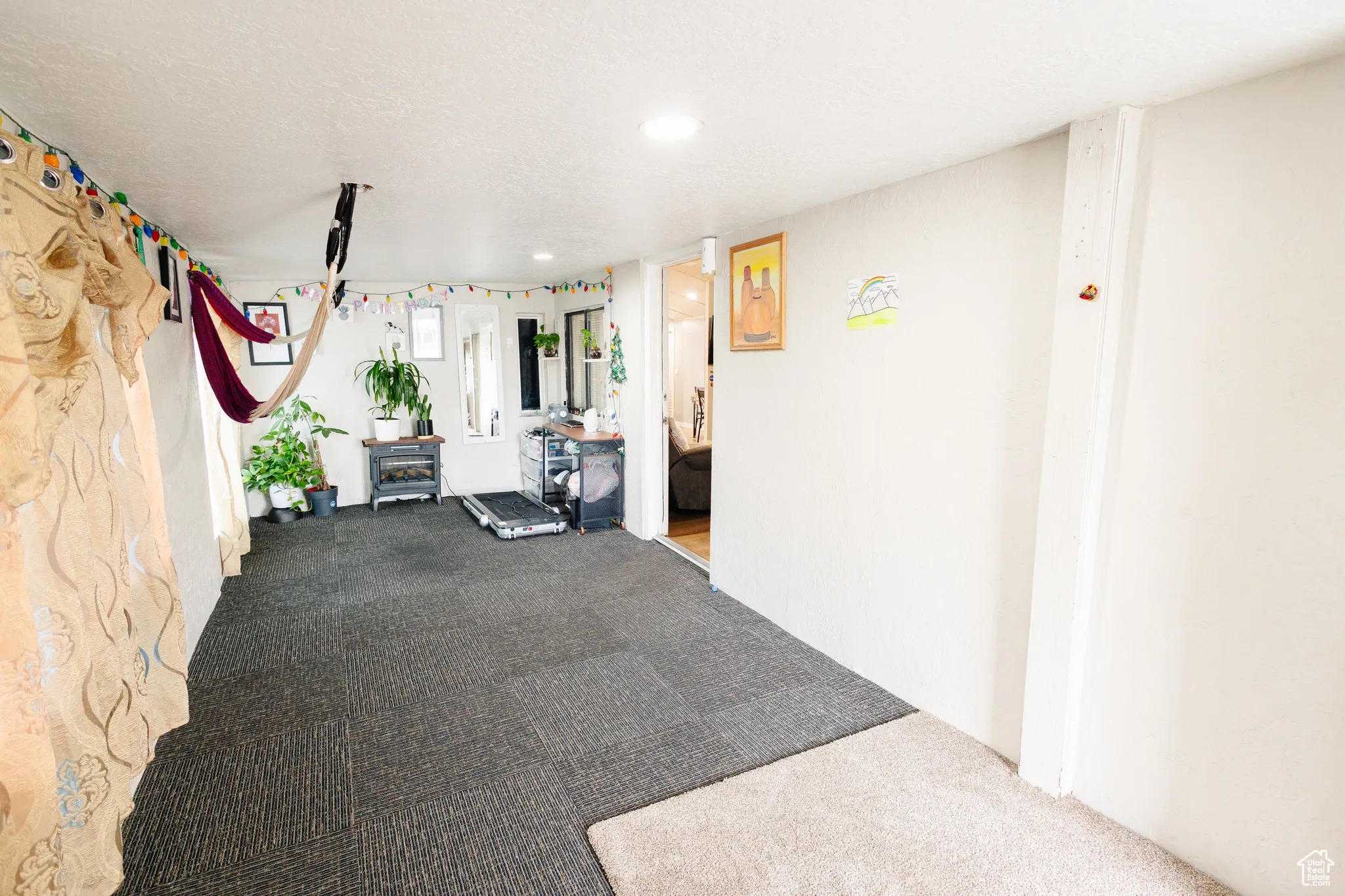 Workout room with a textured ceiling and carpet