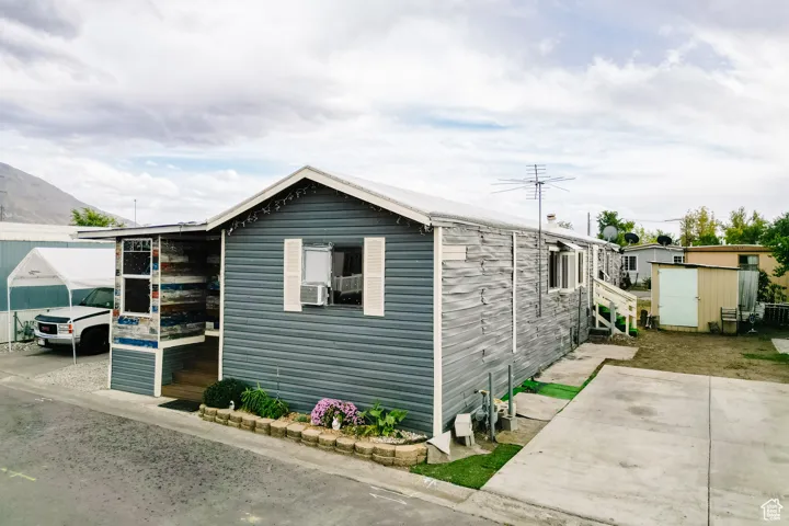 View of front of house featuring a storage shed