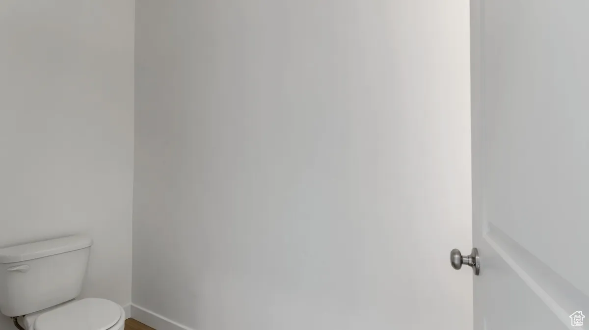 Bathroom with toilet and baseboards