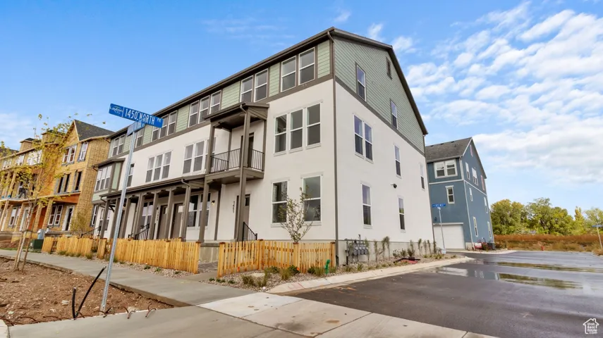 View of building exterior featuring a residential view and a garage