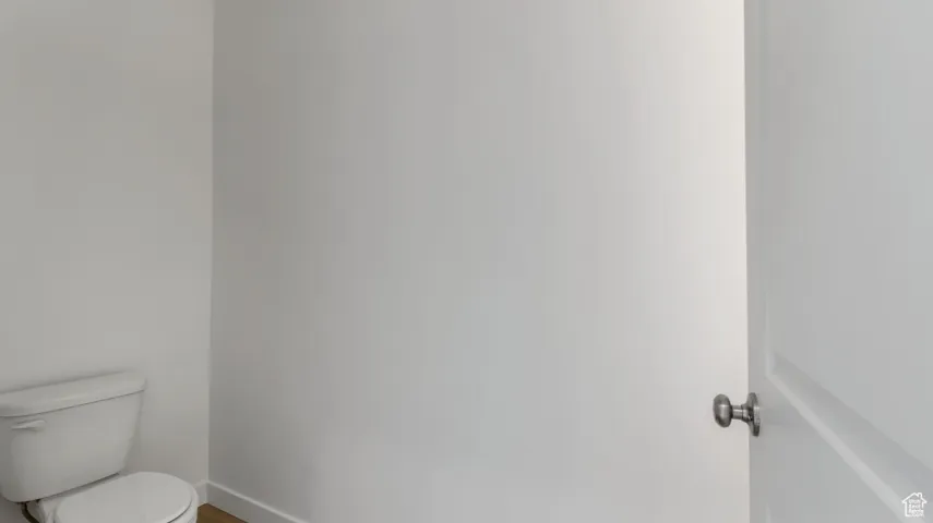 Bathroom with toilet and baseboards