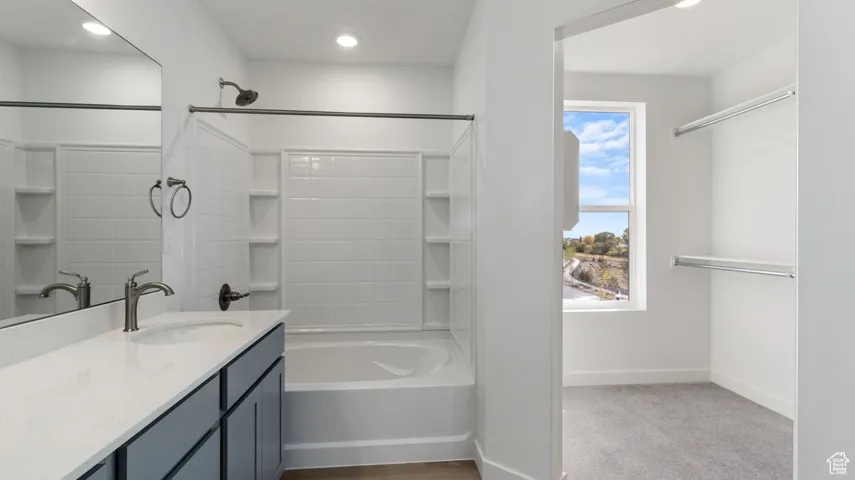 Bathroom featuring shower / bathtub combination, vanity, recessed lighting, and light colored carpet