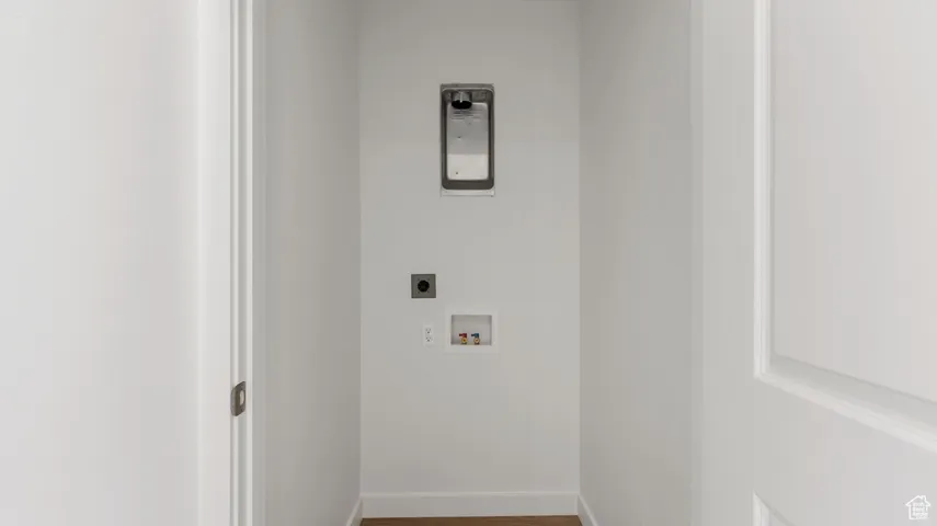 Laundry room featuring wood finished floors, hookup for an electric dryer, and washer hookup