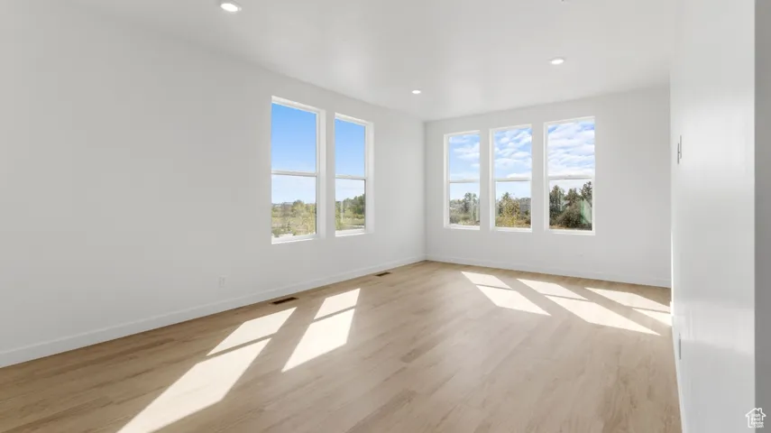 Spare room featuring light wood-type flooring and recessed lighting