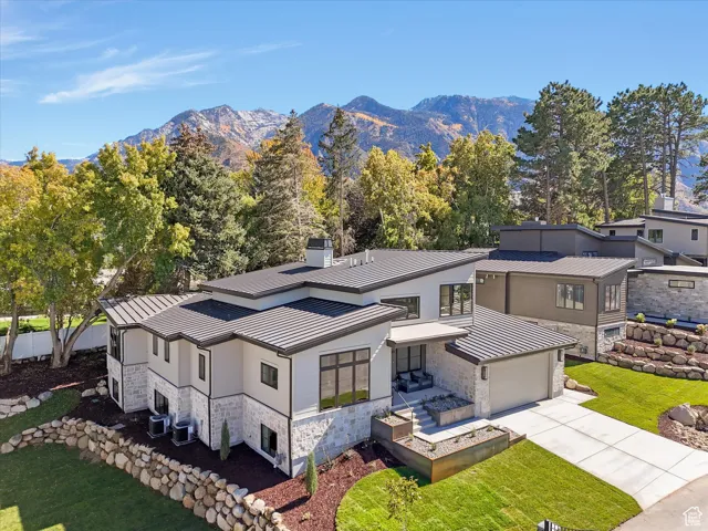 Aerial view of property and surrounding area featuring mountains