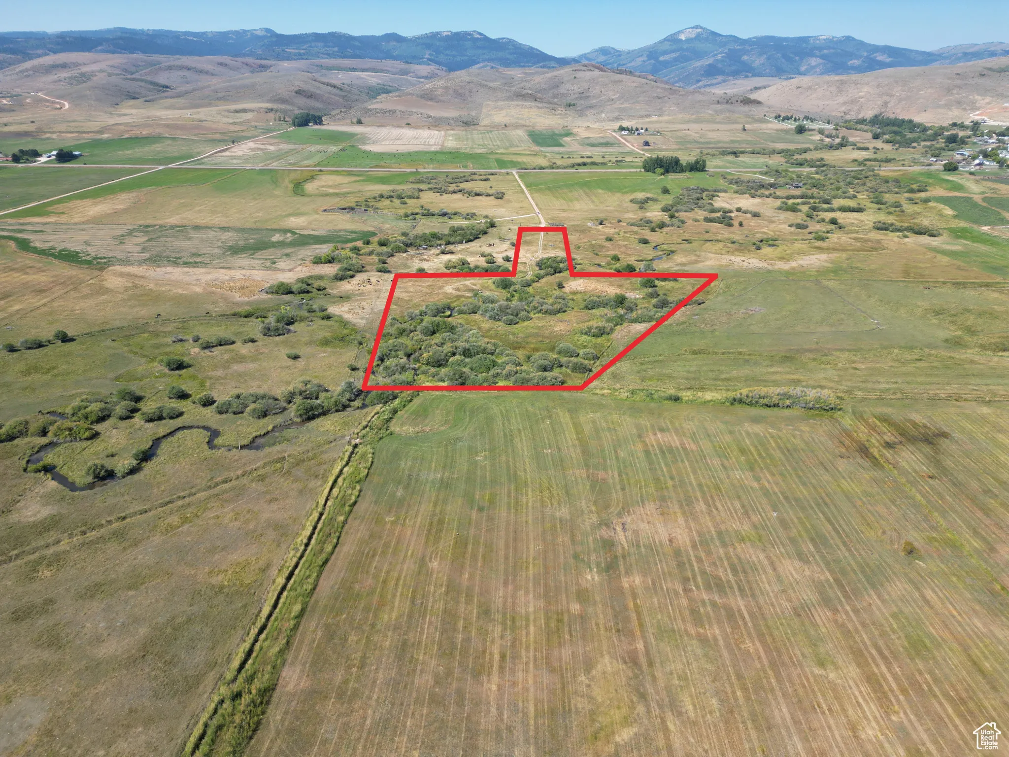 Bloomington 13 acres Aerial view of sparsely populated area featuring a mountainous background and property boundaries highlighted