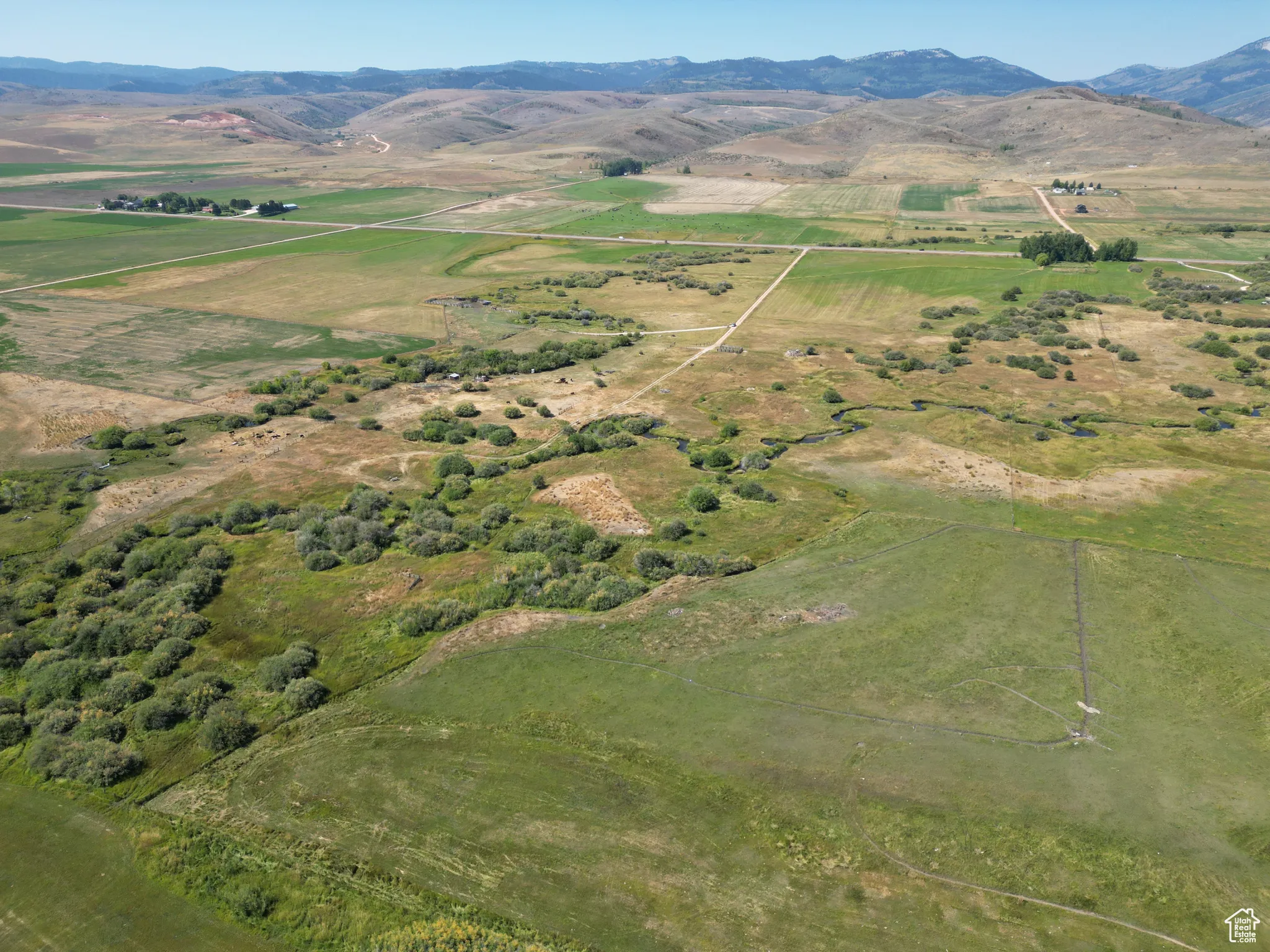 Bloomington 13 acres  Aerial overview of property's location featuring a mountainous background and rural landscape