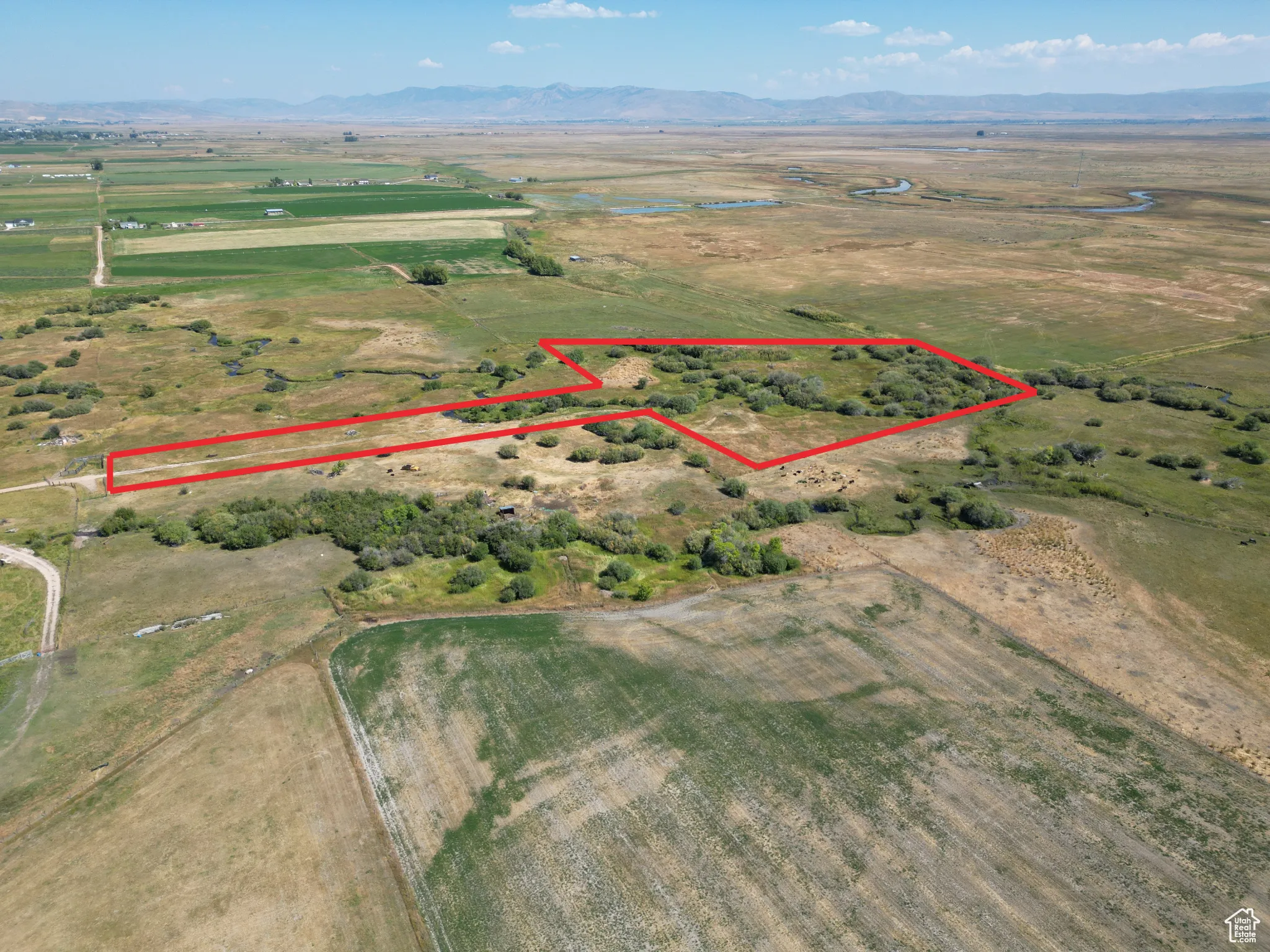 Bloomington 13 acres Aerial view of property's location featuring a mountain backdrop, rural landscape, and property boundaries highlighted