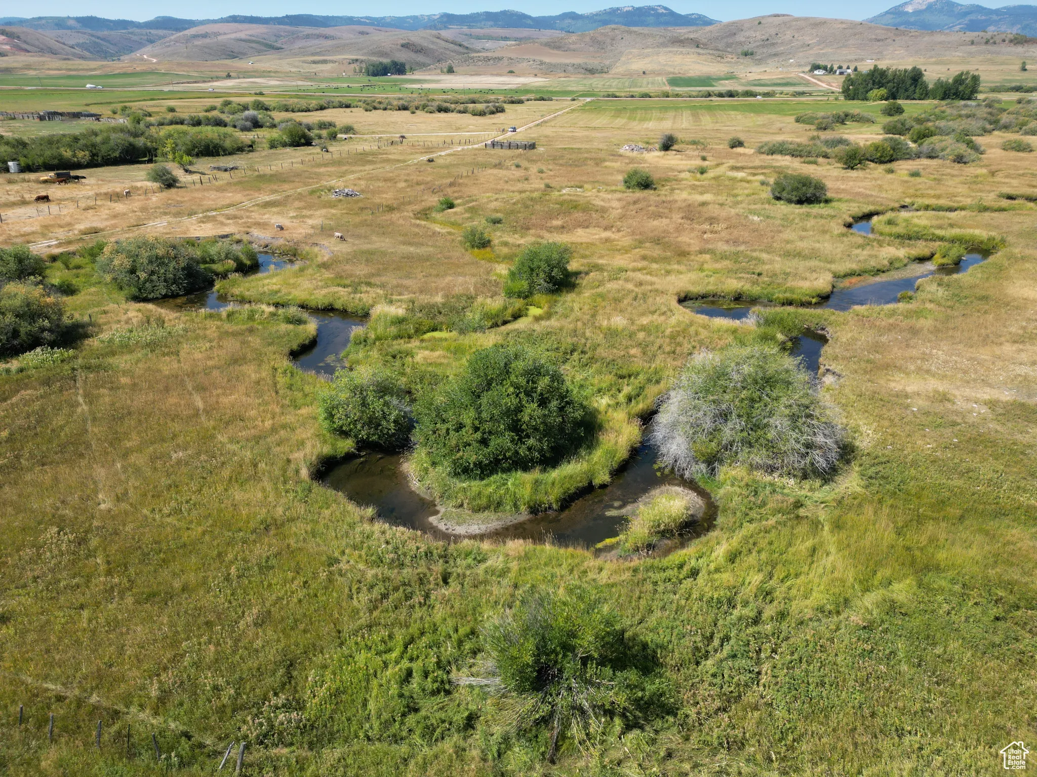 Bloomington 13 acres Aerial view of property and surrounding area with rural landscape and a creek through