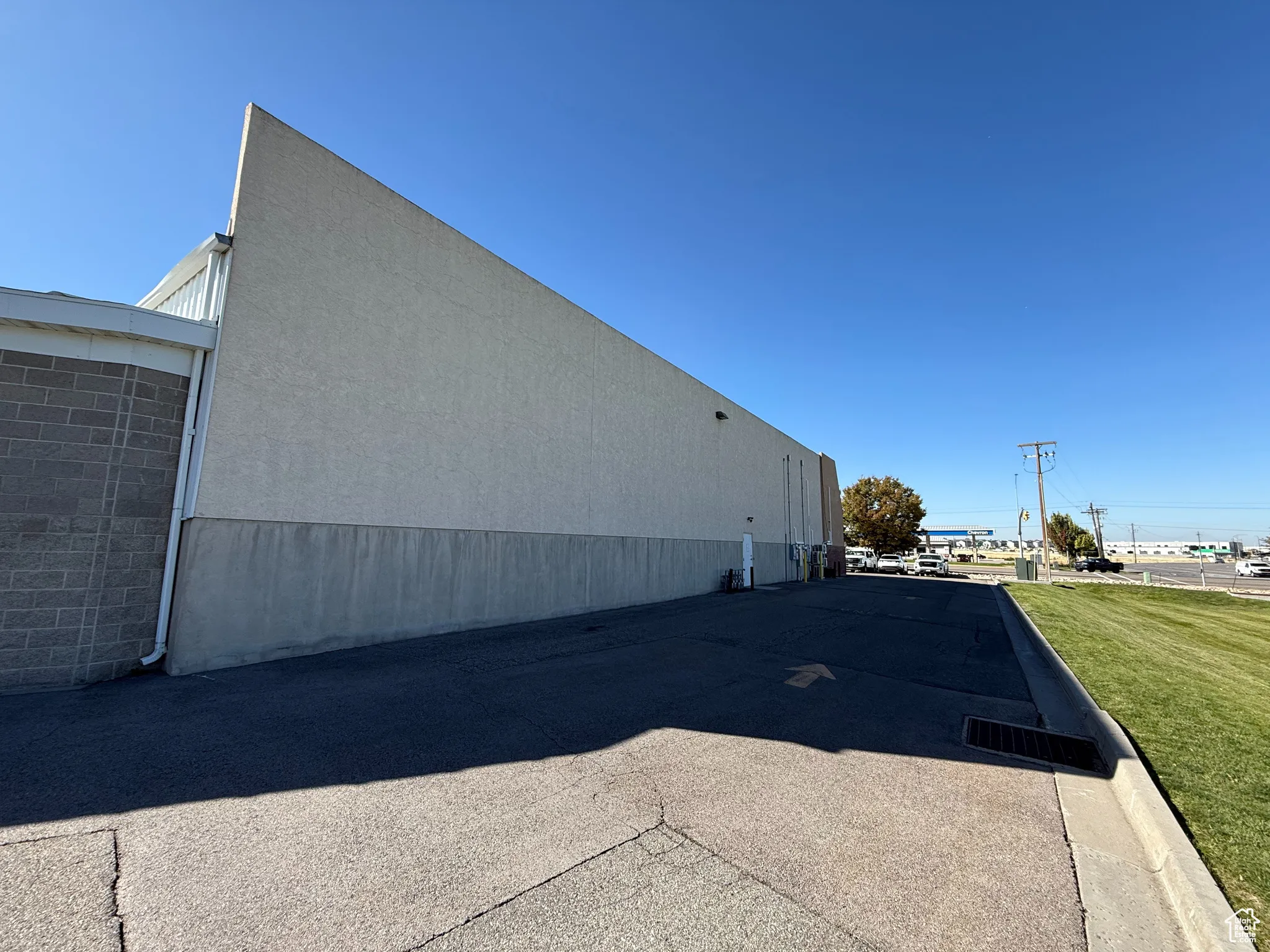View of side of property featuring a lawn and stucco siding