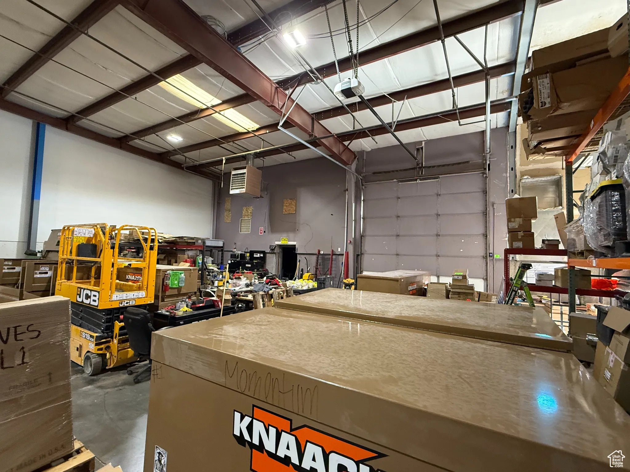 Garage featuring a heating unit and a workshop area