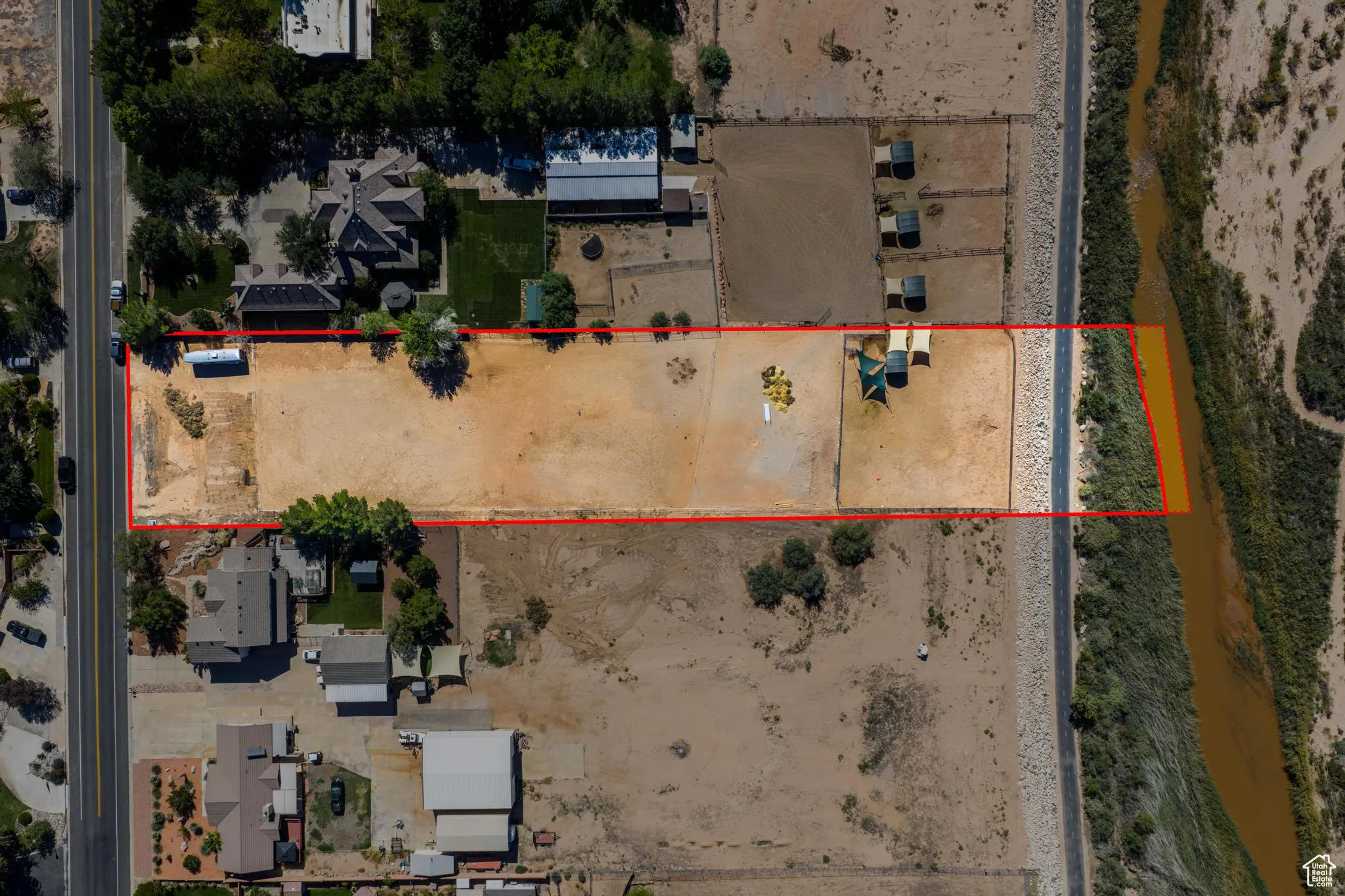 Aerial view of property and surrounding area featuring property boundaries highlighted
