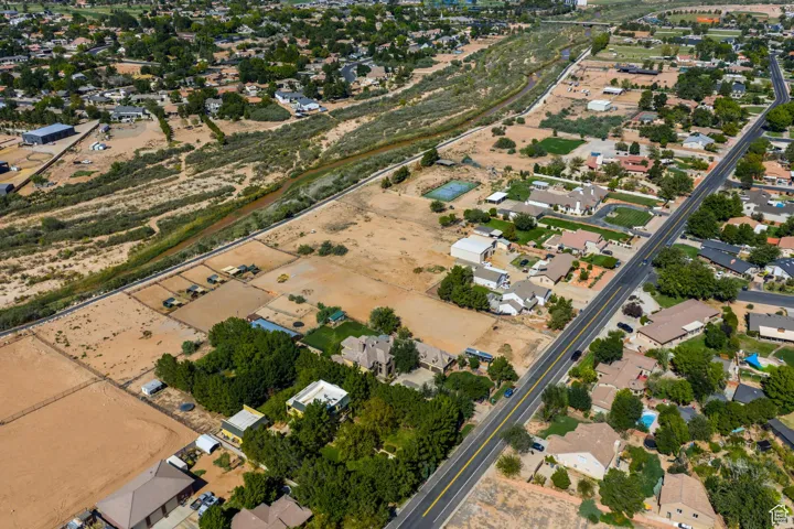 Aerial view of property and surrounding area with nearby suburban area