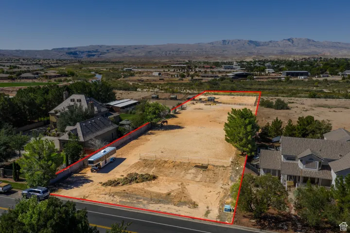 Aerial view of property's location with property parcel outlined and a mountainous background