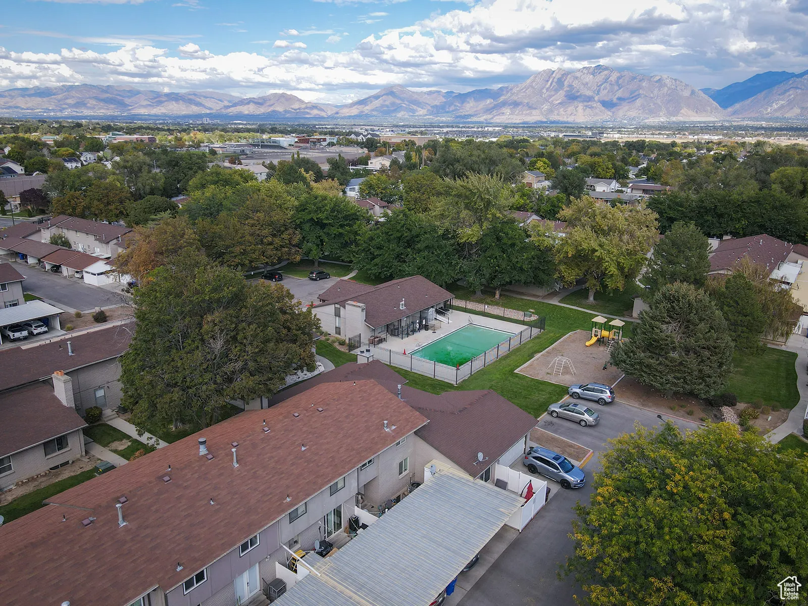 Aerial view of property's location with mountains and a pool area.