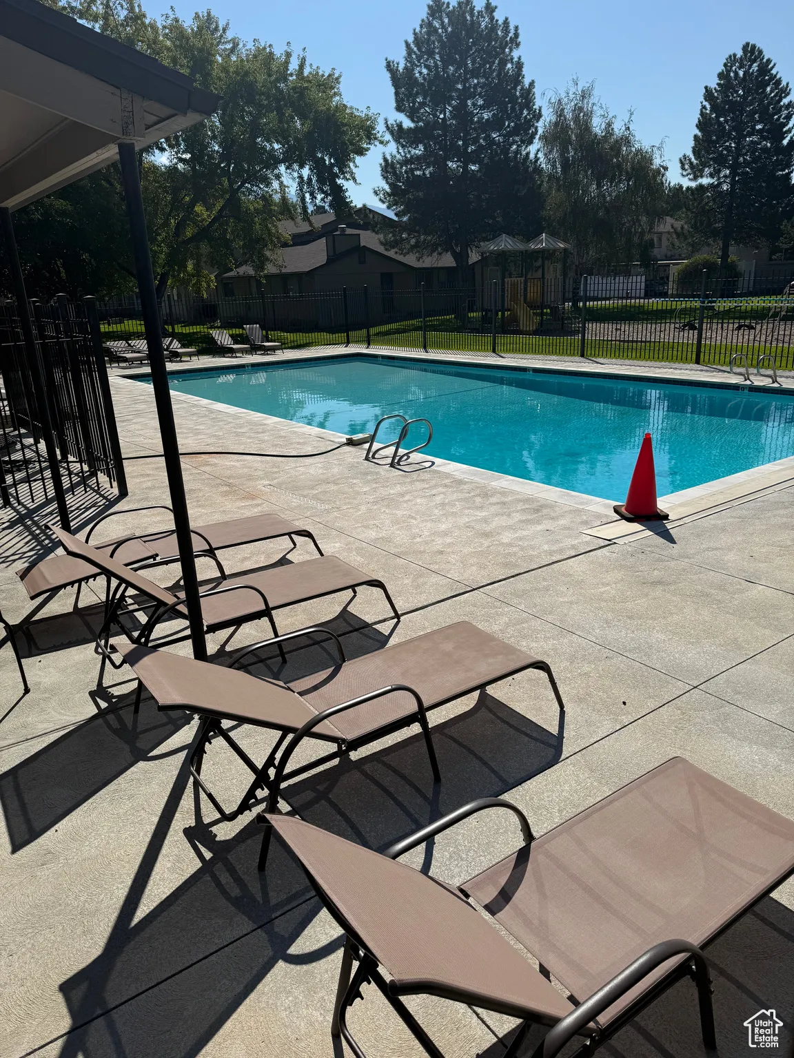 Community pool with a patio