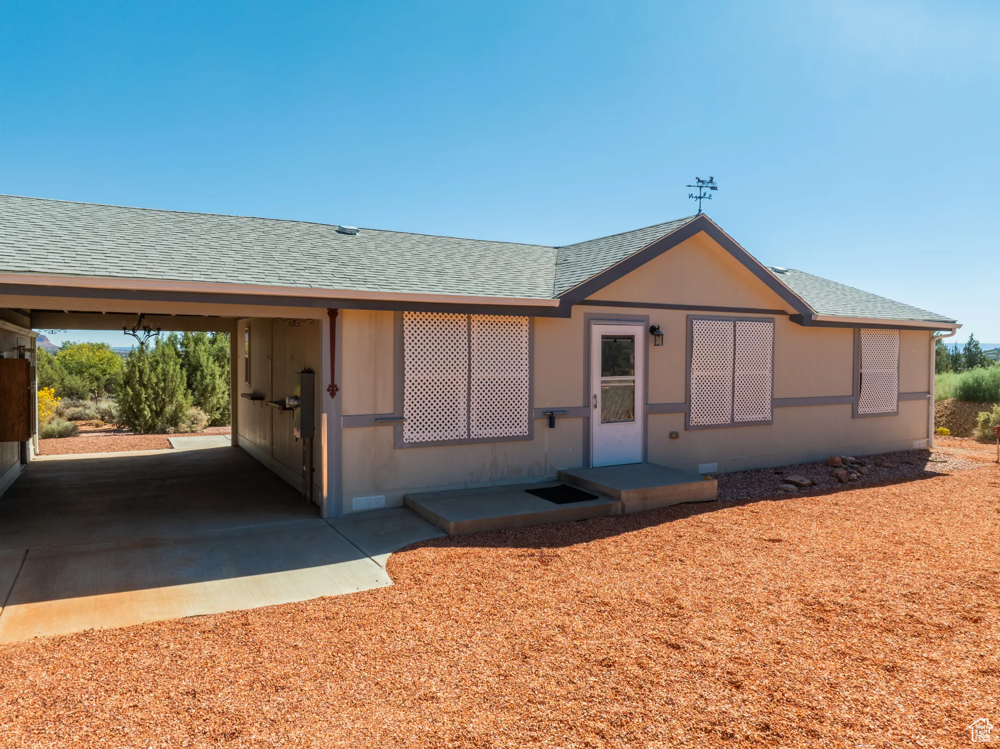 View of front of house with a shingled roof