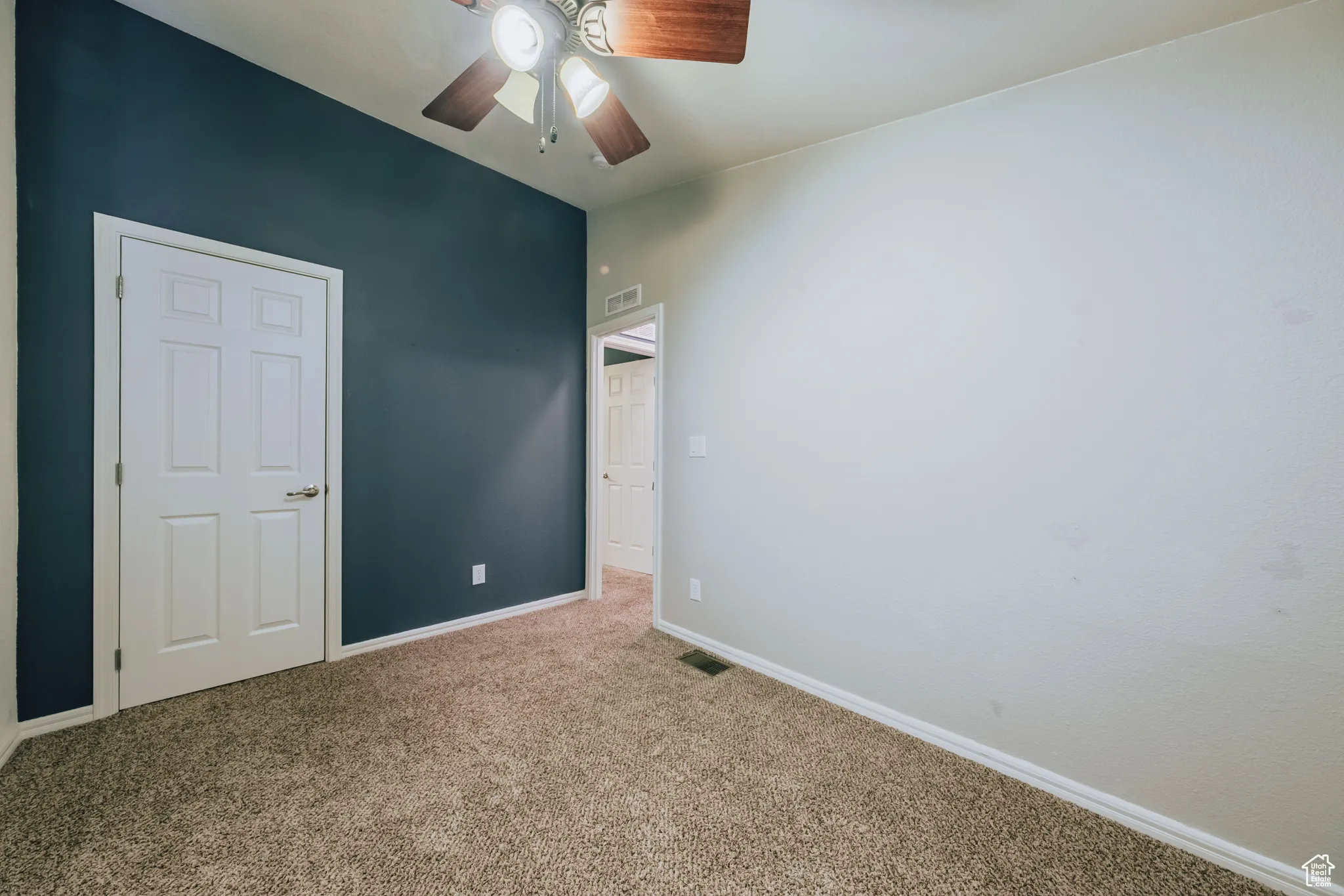 Unfurnished bedroom with carpet and a ceiling fan