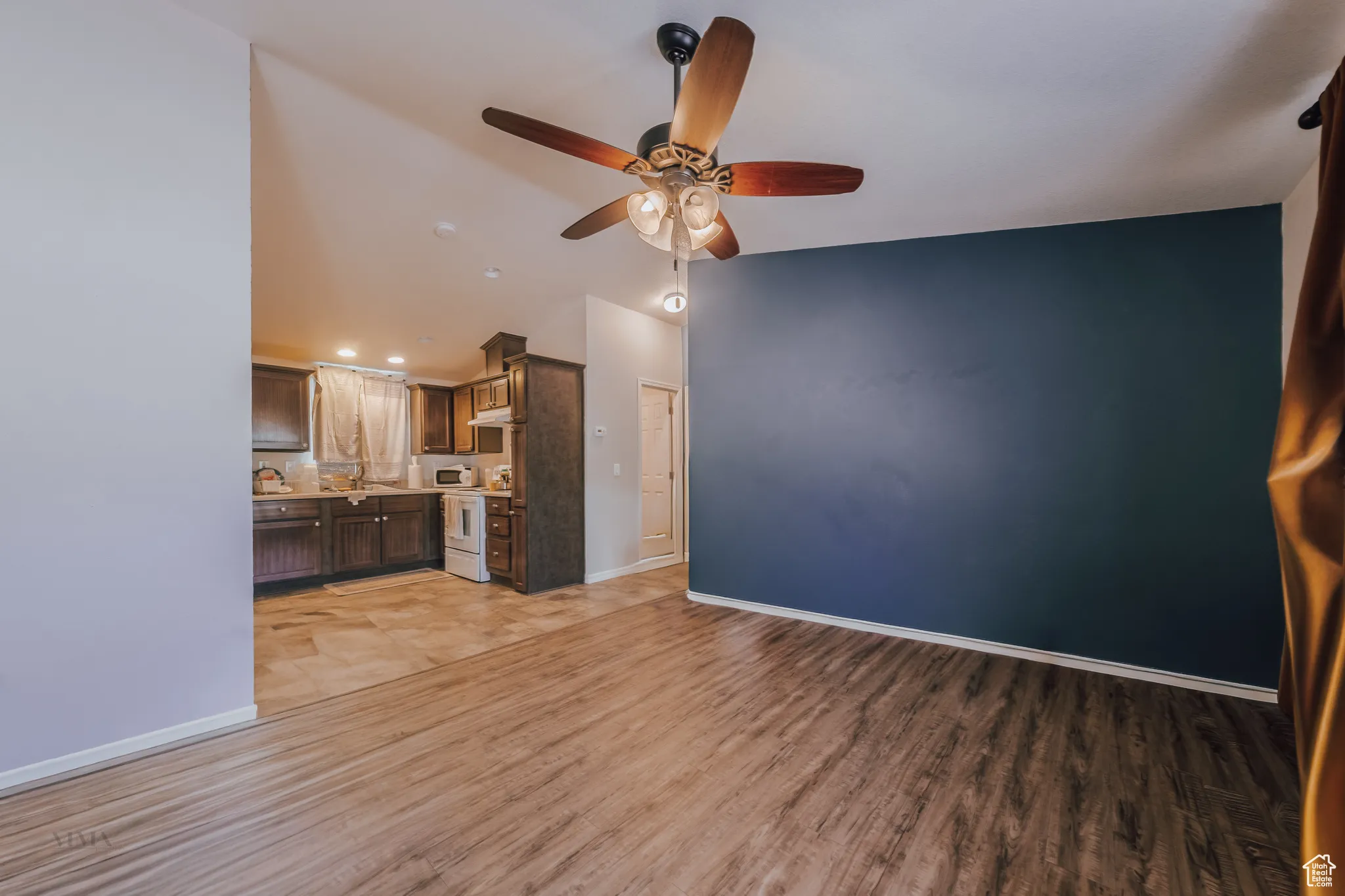 Unfurnished living room with light wood-type flooring, ceiling fan, and recessed lighting