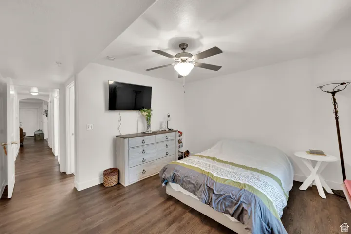 Bedroom featuring dark wood-style floors and a ceiling fan