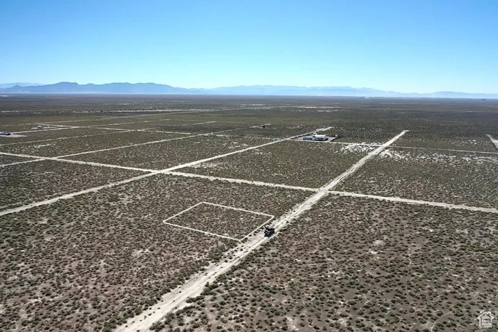 View of vehicle parking with a mountain view, a view of countryside, and view of desert