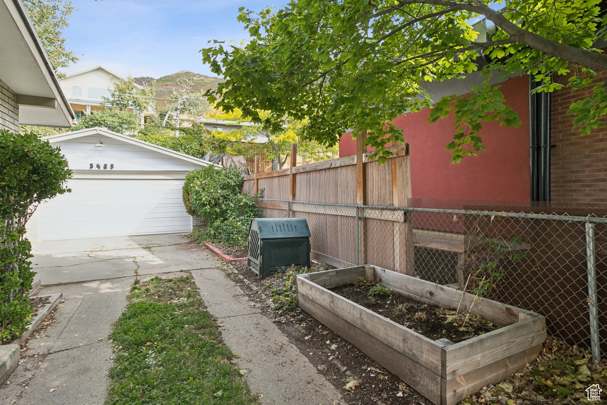 View of yard featuring a vegetable garden, an outdoor structure, and a garage