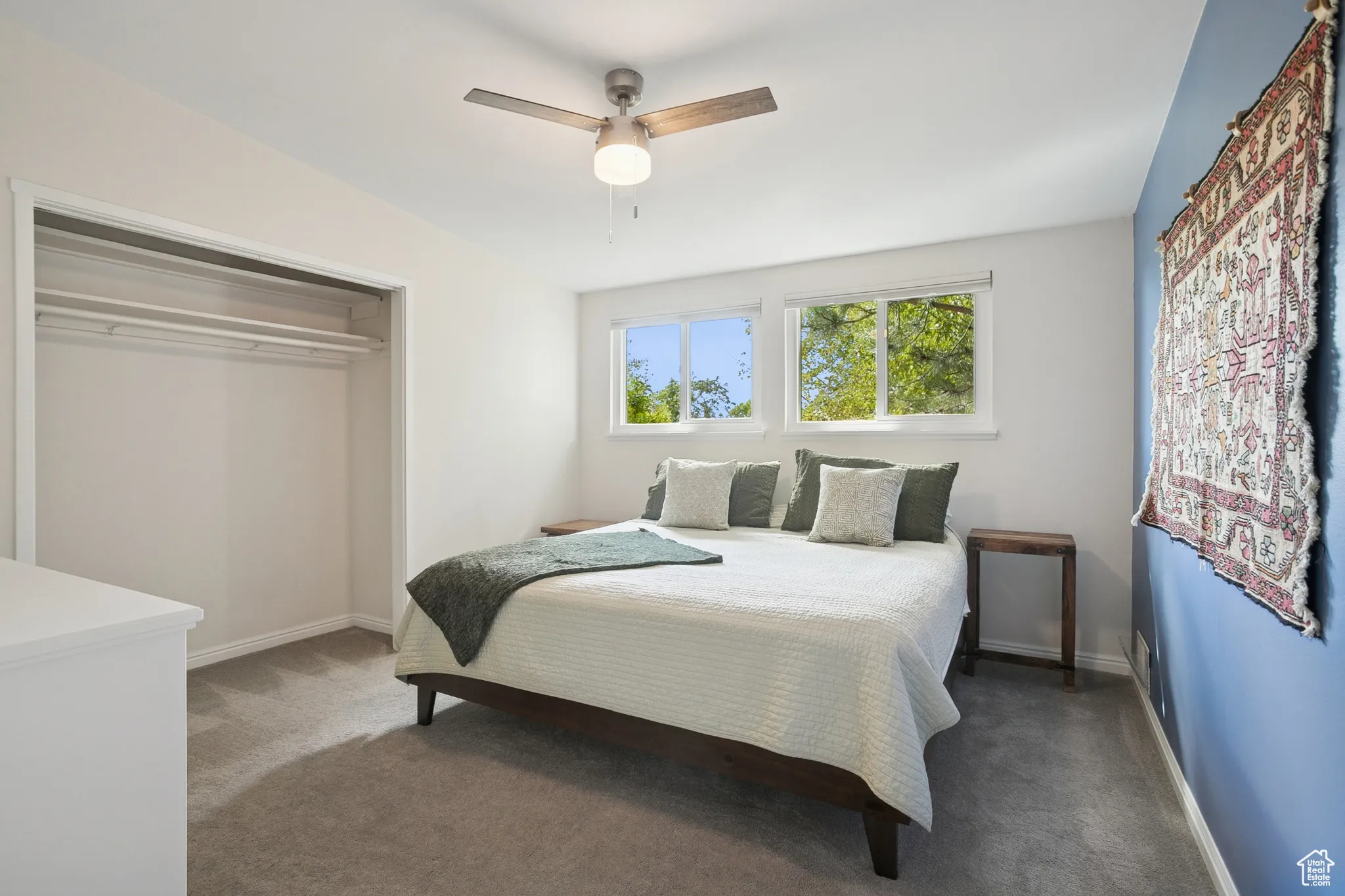 Bedroom with carpet floors, a ceiling fan, and a closet