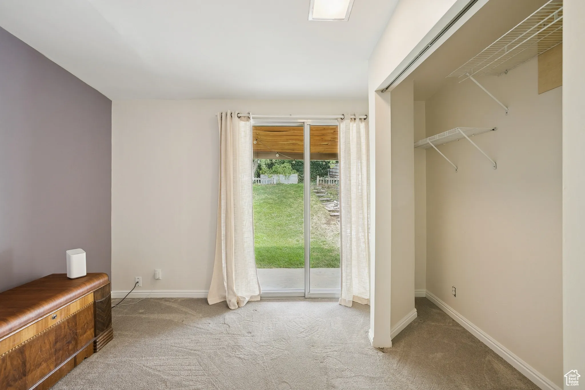 Unfurnished bedroom featuring light colored carpet and access to outside