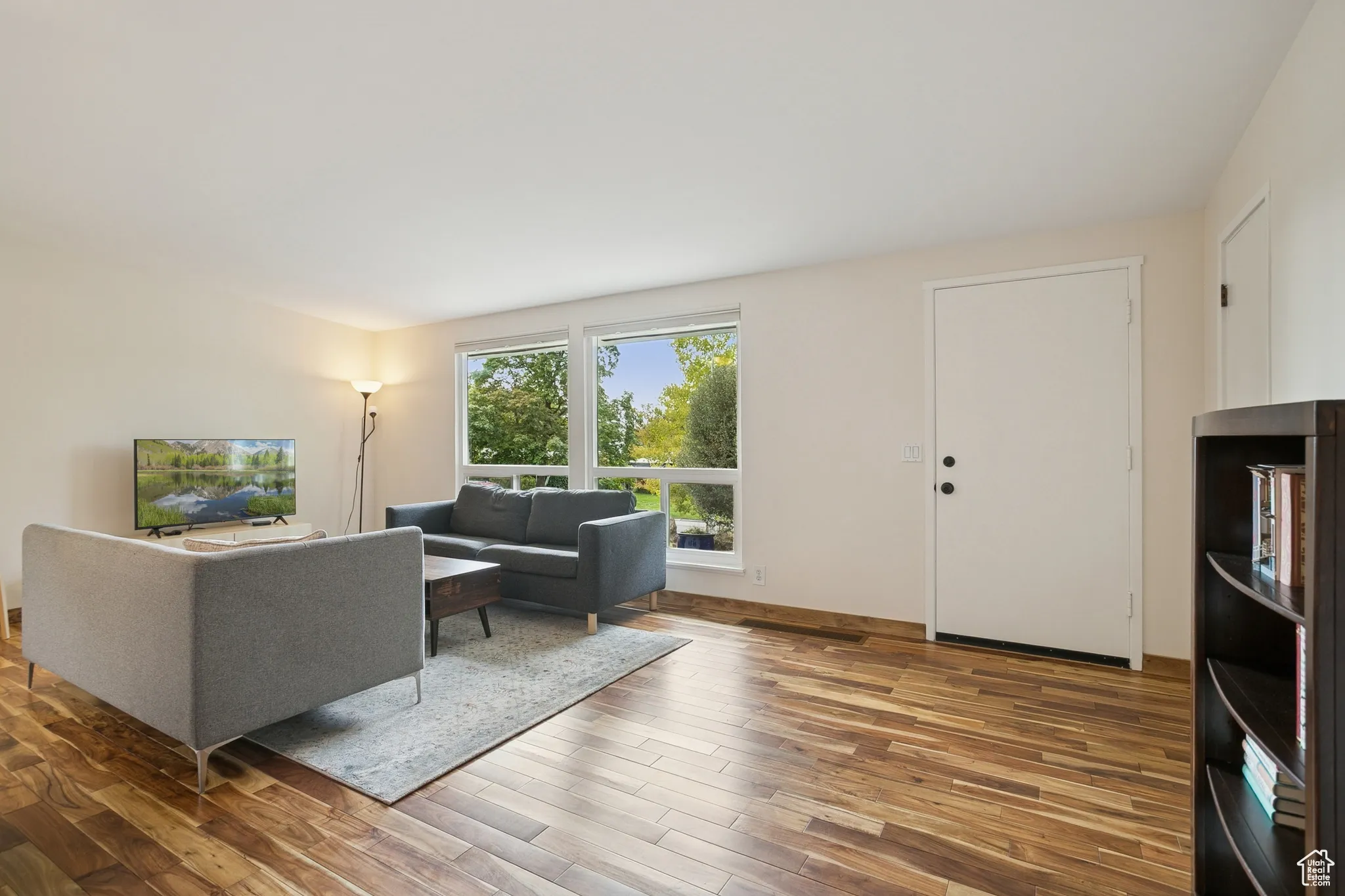 Living room featuring light wood-type flooring and baseboards