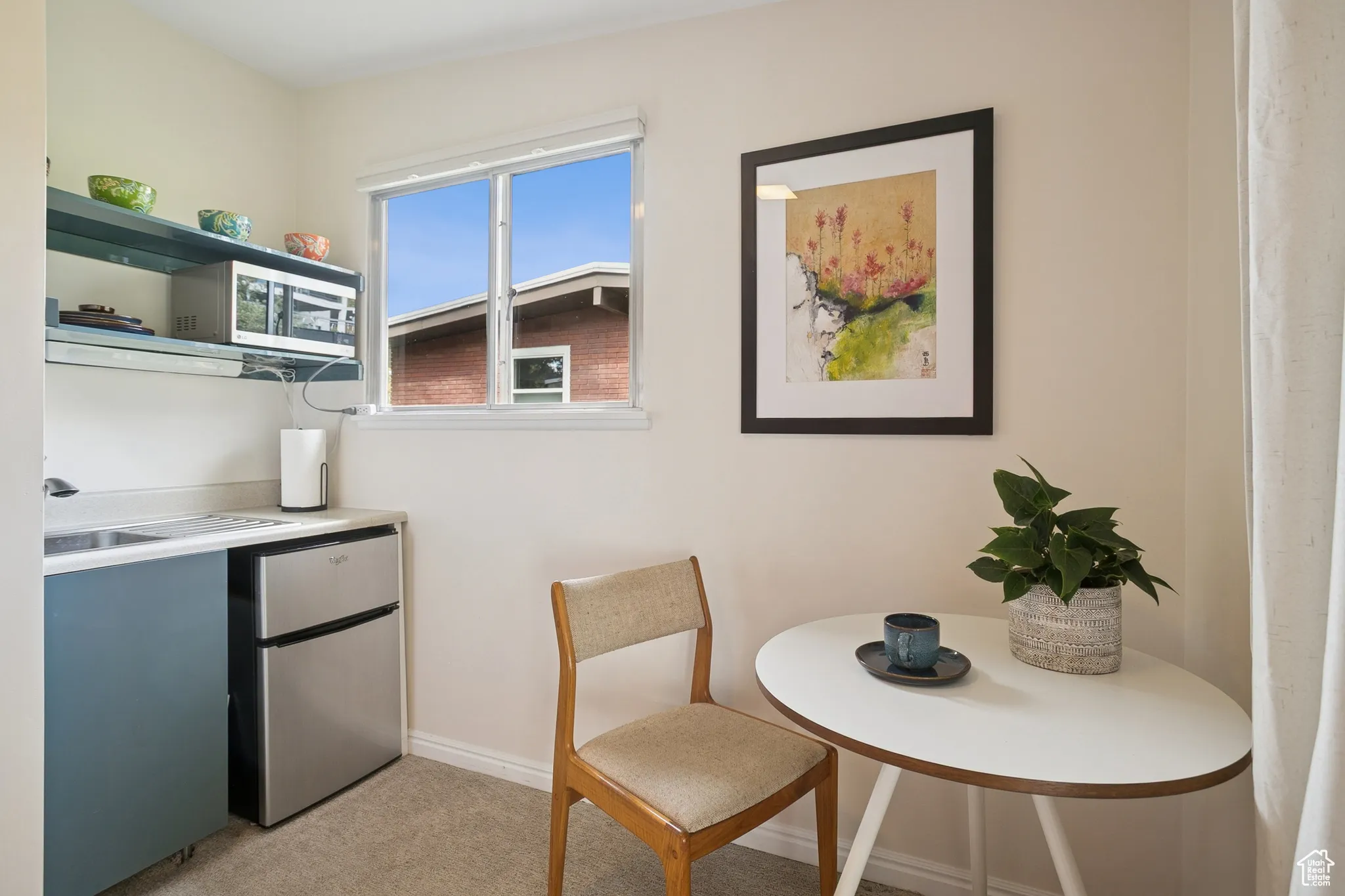 Dining room featuring baseboards and light carpet