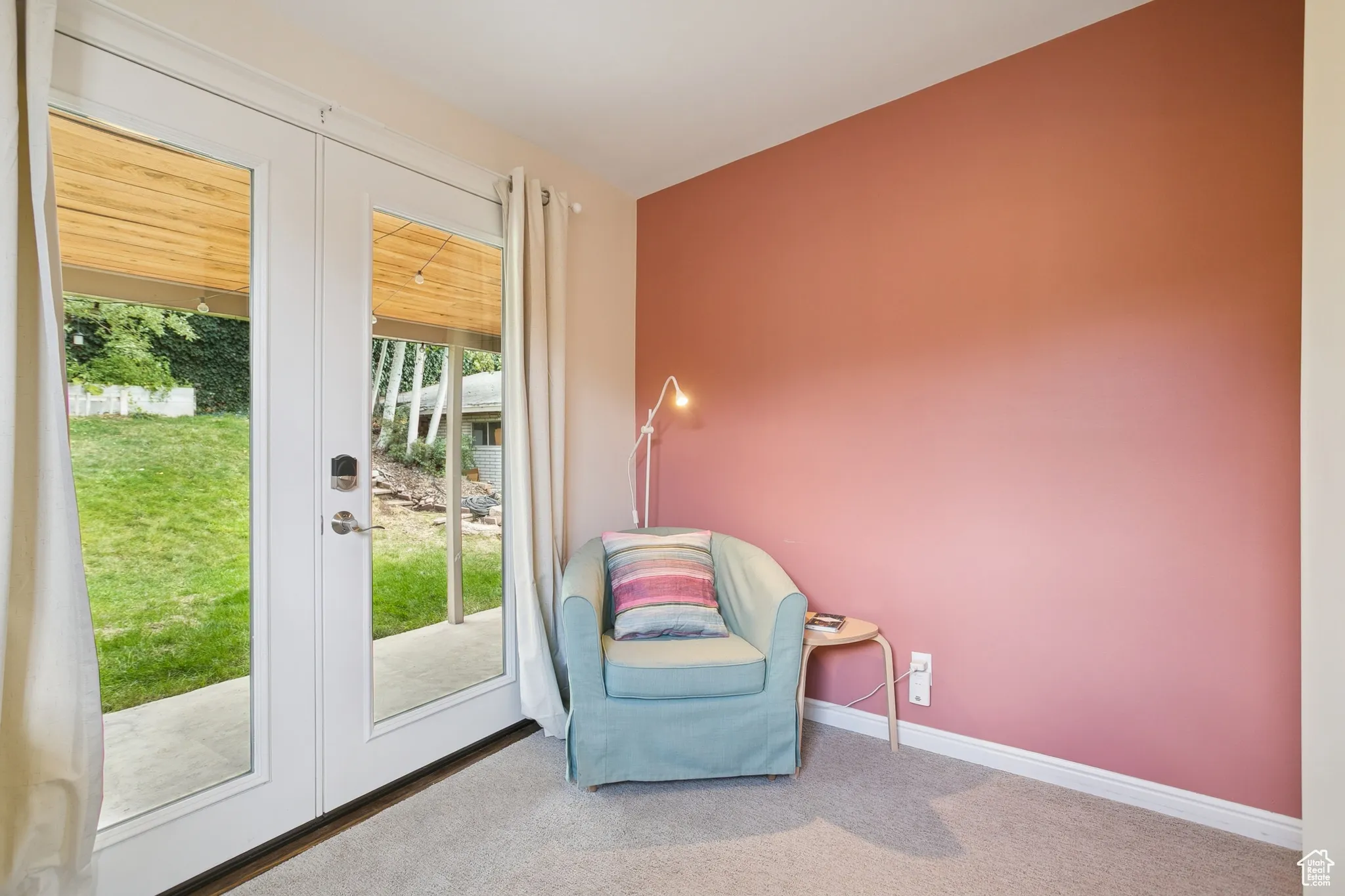 Sitting room featuring french doors and carpet flooring