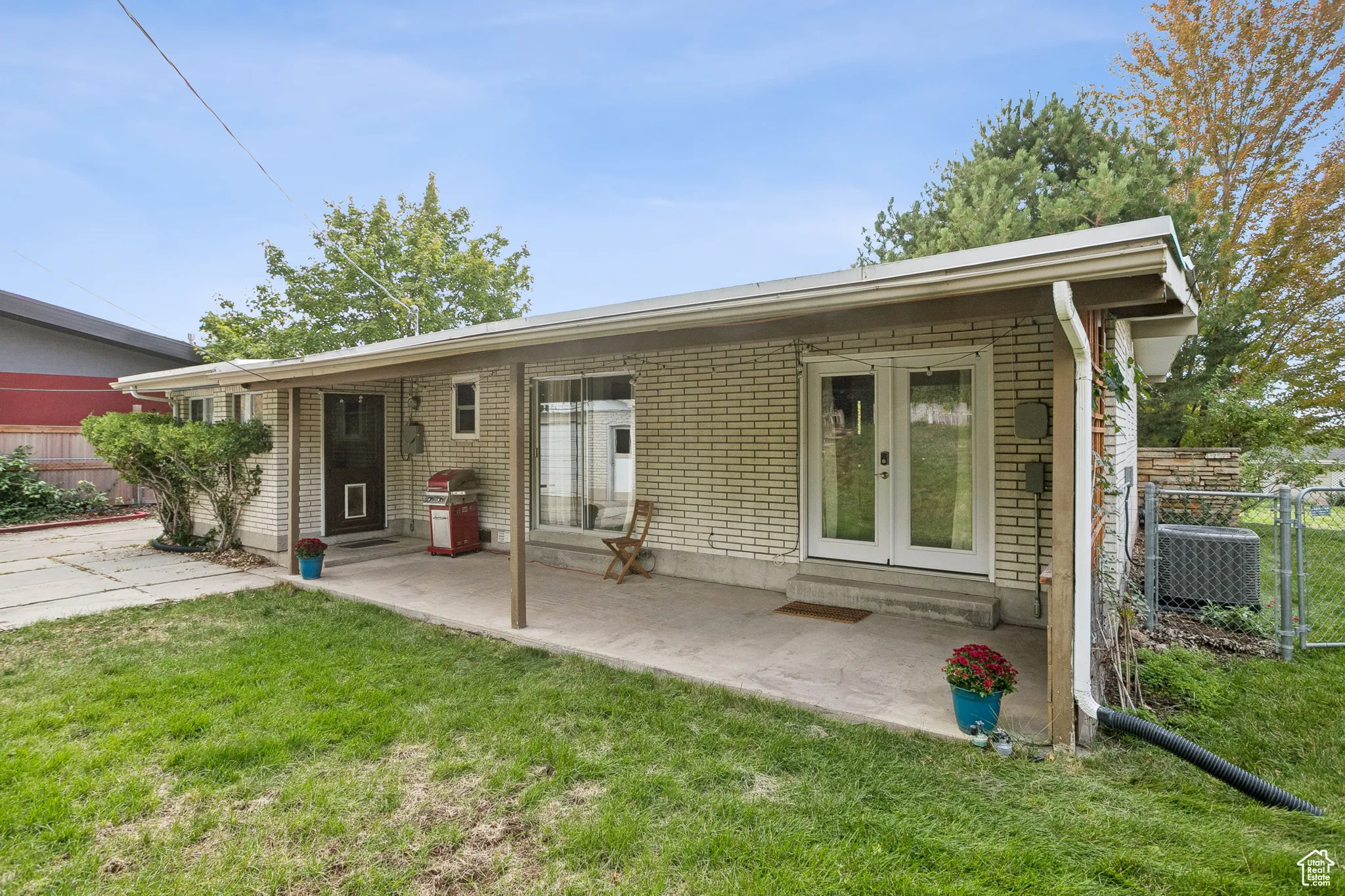 Rear view of house with brick siding, french doors, and entry steps