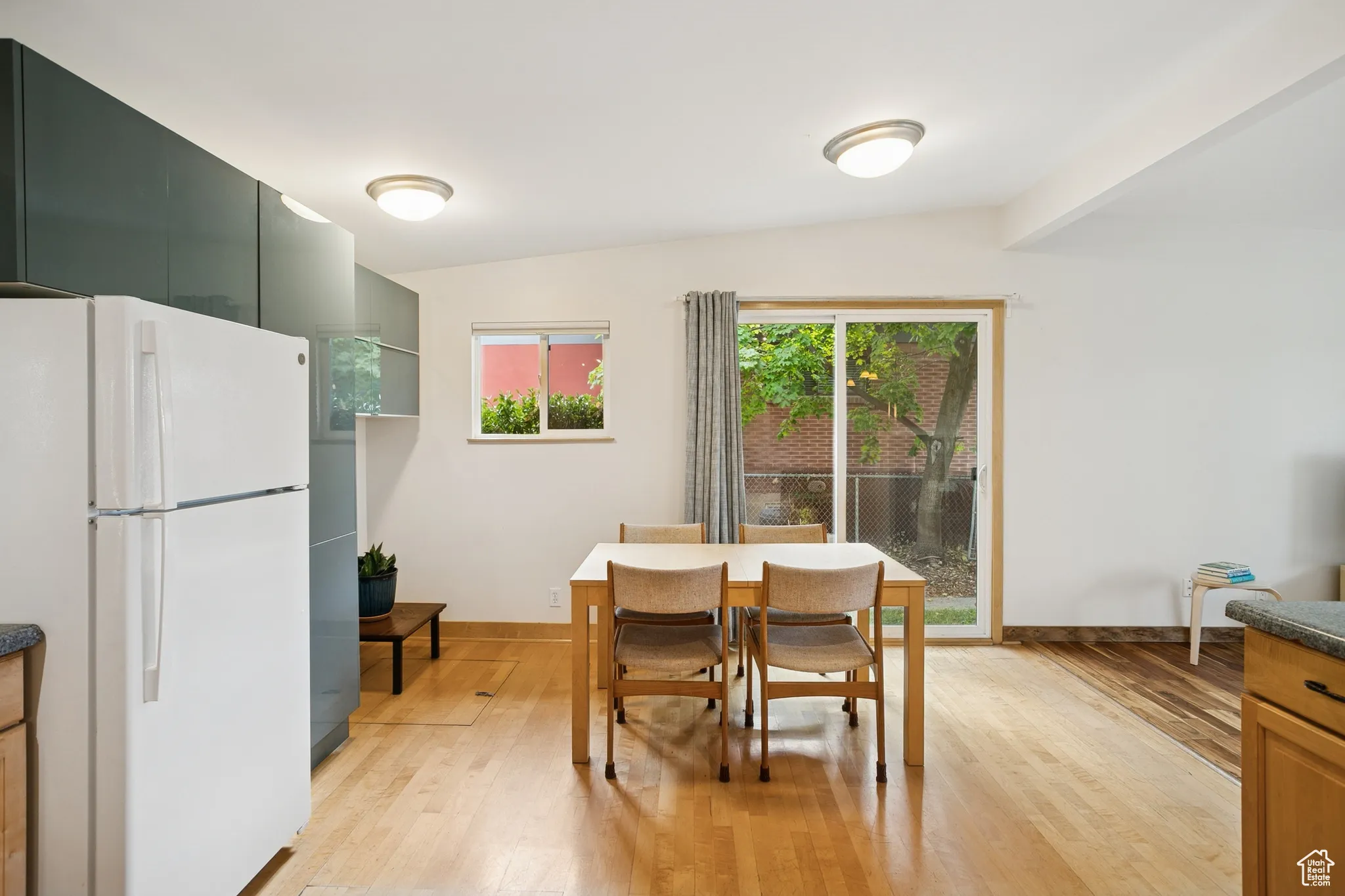 Dining area featuring light wood-style flooring and baseboards