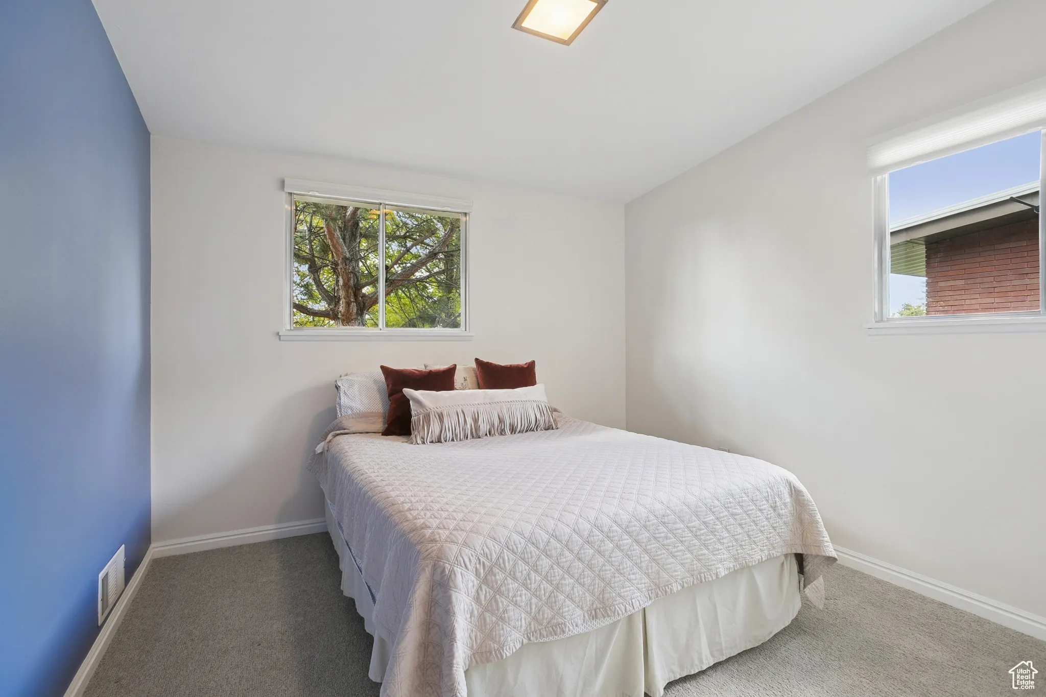 Carpeted bedroom with baseboards