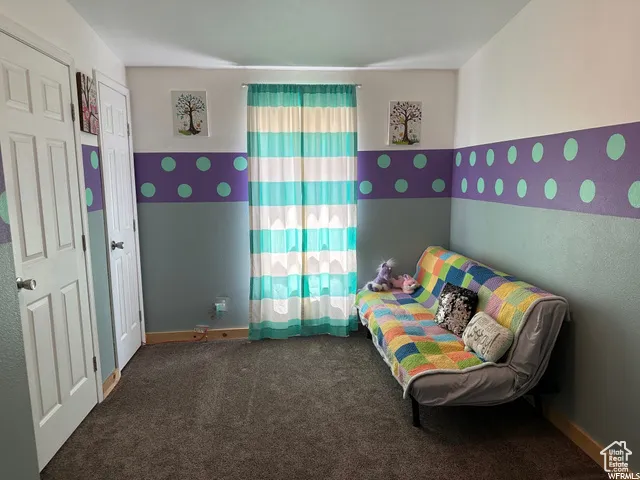 Bedroom with carpet floors and baseboards