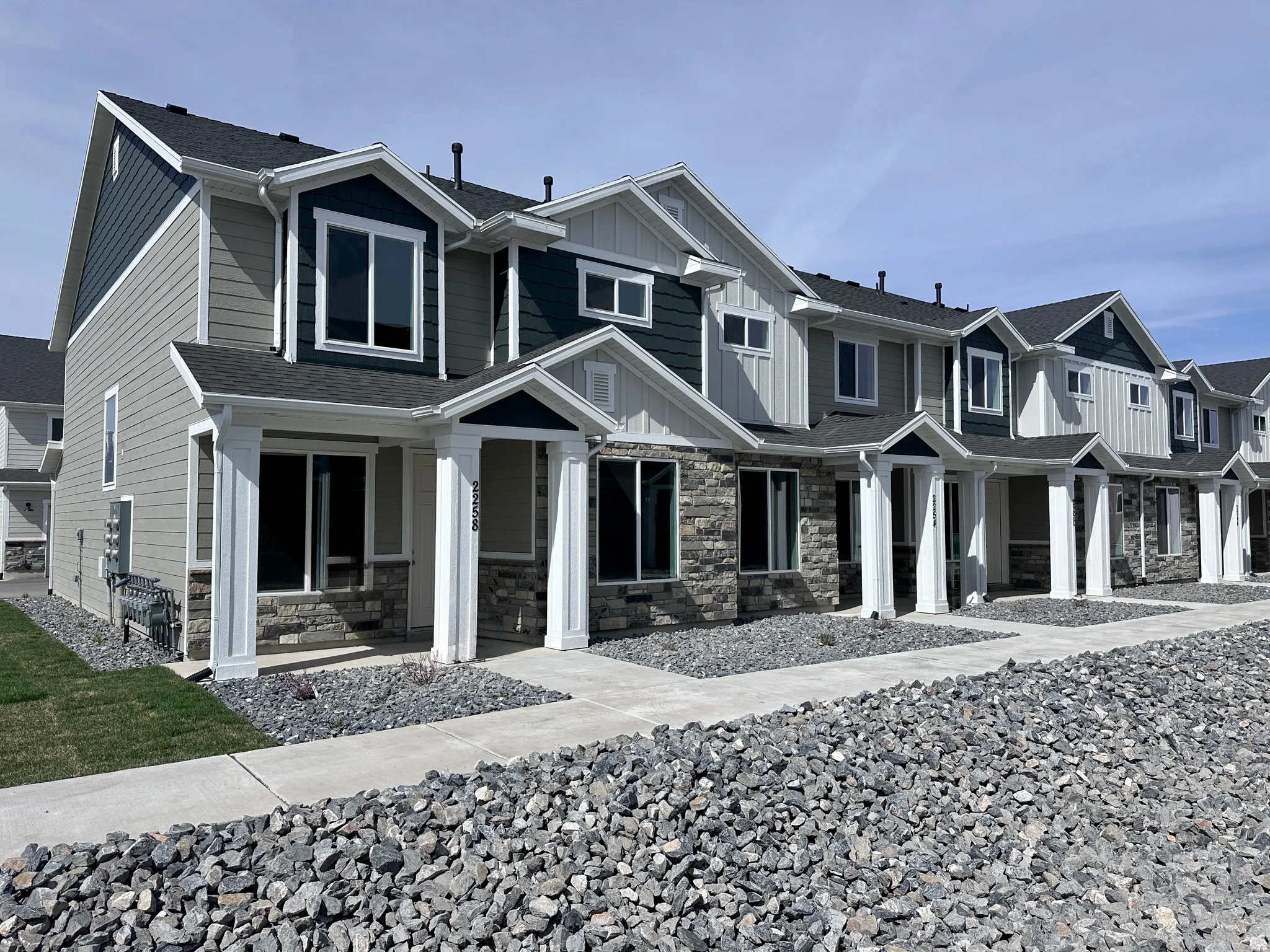 Craftsman inspired home with board and batten siding, stone siding, and covered porch