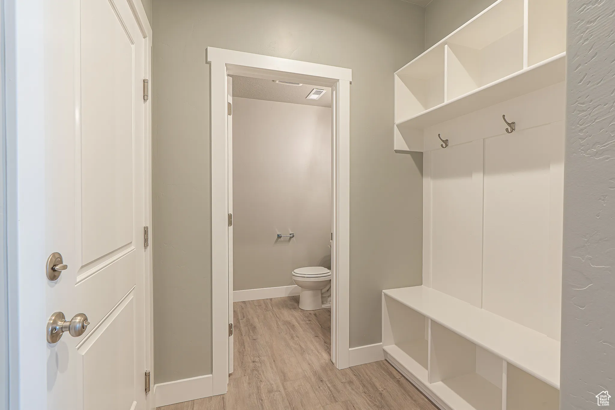 Mudroom featuring baseboards and light wood-style flooring