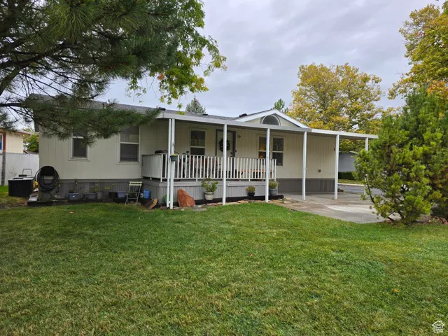 View of front of home featuring a front lawn and a porch