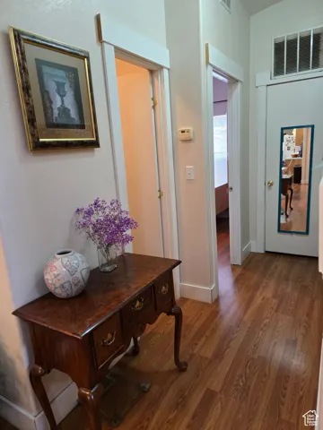 Hallway with wood finished floors and baseboards