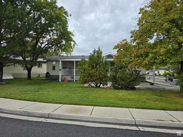 View of front of property featuring a front yard and a porch